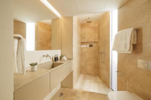 a bathroom with a toilet and a sink and a shower at Palmares Signature Apartments in Lagos