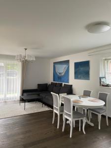 a living room with a table and chairs and a couch at Private Trakai Historical Centre Karaim Two Floor Apartment in Trakai