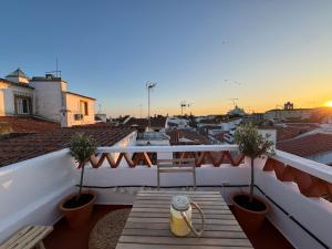 a table on a balcony with a view of a city at Private Alentejo house with a terrace in Évora