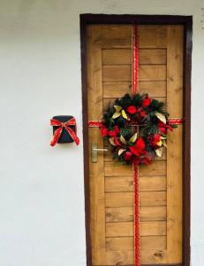 a wooden door with a christmas wreath on it at Janatyy Guest House Suratthani in Suratthani