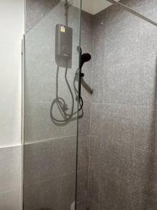 a shower stall with a phone on the wall at Janatyy Guest House Suratthani in Suratthani +22 photos