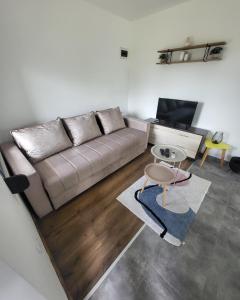 a living room with a couch and a table at Duos East in Soko Banja