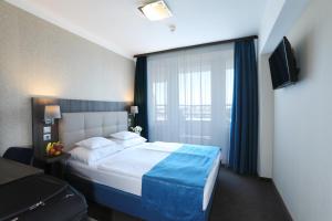 Postel nebo postele na pokoji v ubytování Medos Hotel