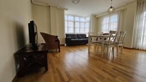a living room with a table and chairs and a couch at Apartamento Cuevas de Mar in Cuevas