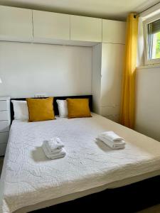 a bedroom with a bed with two towels on it at Apartment Malija Cikloped in Izola