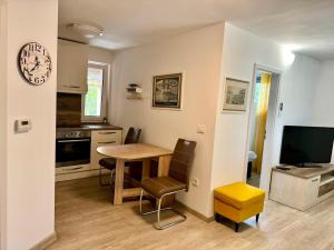 a kitchen and dining room with a table and chairs at Apartment Malija Cikloped in Izola