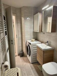 a bathroom with a washing machine and a sink at Apartment Malija Cikloped in Izola +9 photos