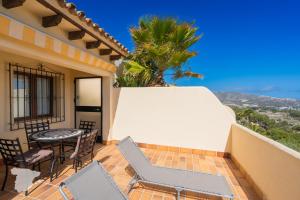 a balcony with a table and chairs on a house at Casa Horizonte in Moraira