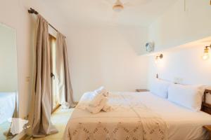 a teddy bear sitting on a bed in a room at Casa Horizonte in Moraira +14 photos