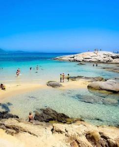 a group of people in the water at a beach at Casa vacanza Muravera "House Gardens" in Muravera +22 photos