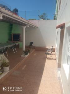 a patio with chairs and a table in a building at Apartamento Lago Pereira in Muxia