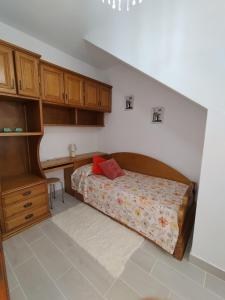 a bedroom with a bed and a desk at Apartamento Lago Pereira in Muxia