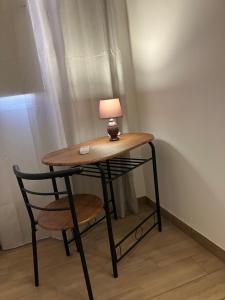 a table and a chair with a lamp on it at bayekou trapani in Trapani +20 photos