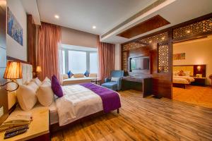 a hotel room with a bed and a desk at Tiaraa Hotels & Resorts in Rāmnagar