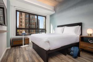 a bedroom with a large bed and a window at Motto by Hilton Philadelphia Rittenhouse Square in Philadelphia
