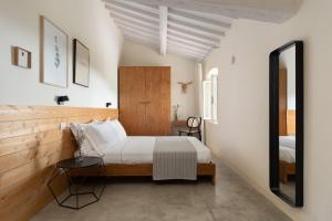 a bedroom with a bed and a mirror at Podere Castellare in Pelago