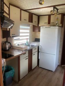 a kitchen with a white refrigerator and a sink at 4U Pokój w domku holenderskim Rooms in Tinyhouse in Zgorzelec +15 photos