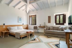 a bedroom with a large bed and a couch at Podere Castellare in Pelago