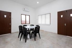 a dining room with a table and black chairs at Dream - Autumn at Pinji Ipoh Town in Ipoh