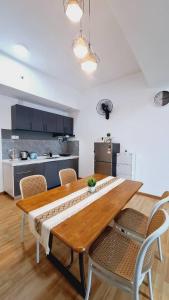 a dining room table with chairs and a kitchen at Imperium Residence 1 Queen bed Sea View in Kuantan