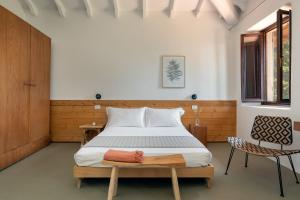 a bedroom with a bed and a chair at Podere Castellare in Pelago