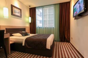 Postel nebo postele na pokoji v ubytování Hotel Nartel