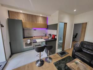 a kitchen and living room with a couch and a table at Nassima in Malesherbes