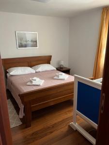 a bedroom with a bed and a tv in it at Apartment Finally in Kastel Stari