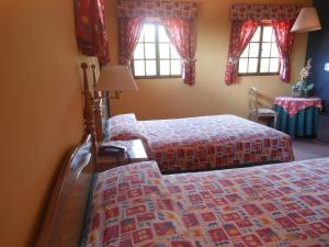 
A bed or beds in a room at Hotel Viejo Molino Coroico
