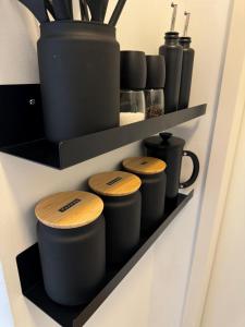 a shelf with some pots and cups on it at Apartmenthaus Buxtehude St -Petri-Platz Apt 2 in Buxtehude