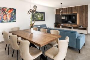 a dining room with a blue couch and a table and chairs at Villa Vista Verde by IstriaLux in Svetvinčenat