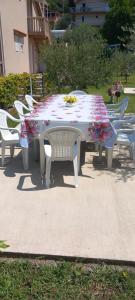 a table with a floral table cloth on it at Rada in Kavač