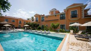 a swimming pool in front of a building at Ema Houses in Antalya