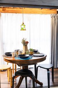 a dining room table with plates on it at Holiday cottage BEPPU ICHIYA in Beppu