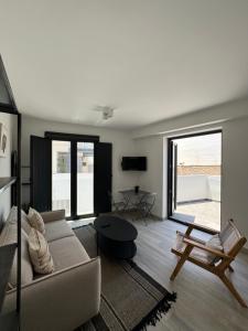 a living room with a couch and a table at Loft Huerto Old Town in Estepona