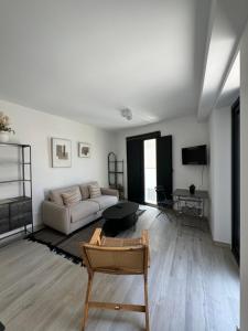 a living room with a couch and a table at Loft Huerto Old Town in Estepona +8 photos