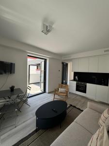 a living room with a couch and a table at Loft Huerto Old Town in Estepona +8 photos