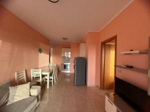 a living room with a couch and a kitchen with a table at Horizon Apartments - Sea & Mountain View -Modern & Spacious Stay in Orikum