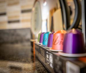 a row of colorful cups sitting on a counter at 10 Summerhouse Mews in York