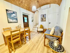 a living room with a dining room table and chairs at Private Alentejo house with a terrace in Évora +27 photos