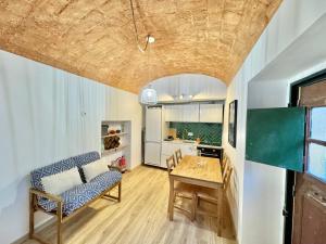 a kitchen and dining room with a table and a couch at Private Alentejo house with a terrace in Évora