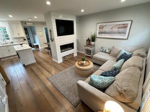 a living room with a couch and a fireplace at Beautifully Renovated 2 Bed 2 Bath Private Home in Newport