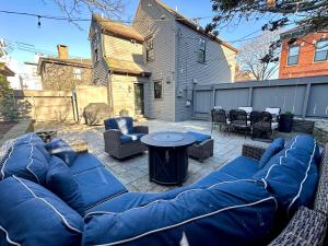 a patio with a blue couch and a table at Beautifully Renovated 2 Bed 2 Bath Private Home in Newport