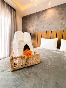 a bedroom with a bed with white towels and an orange flower at Aloha Palace Hotel in Jijoca de Jericoacoara +26 photos