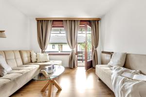 a living room with a couch and a table at Apartments Svetina in Bled