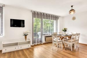 a dining room with a table and chairs and a window at Apartments Svetina in Bled