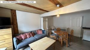 a living room with a couch and a table at Blaue Perle Templin in Templin