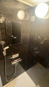a bathroom with a shower with a glass wall at Sound Garden Biei - Forest suite in Biei +39 photos