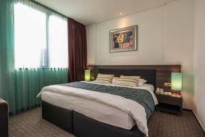 Postel nebo postele na pokoji v ubytování Hotel Nartel