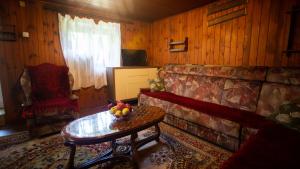 a living room with a couch and a table with fruit on it at Ethno guesthouse Tara in Mojkovac
